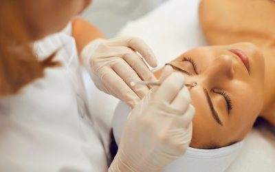 Woman receiving an acne extraction from a skin specialist.