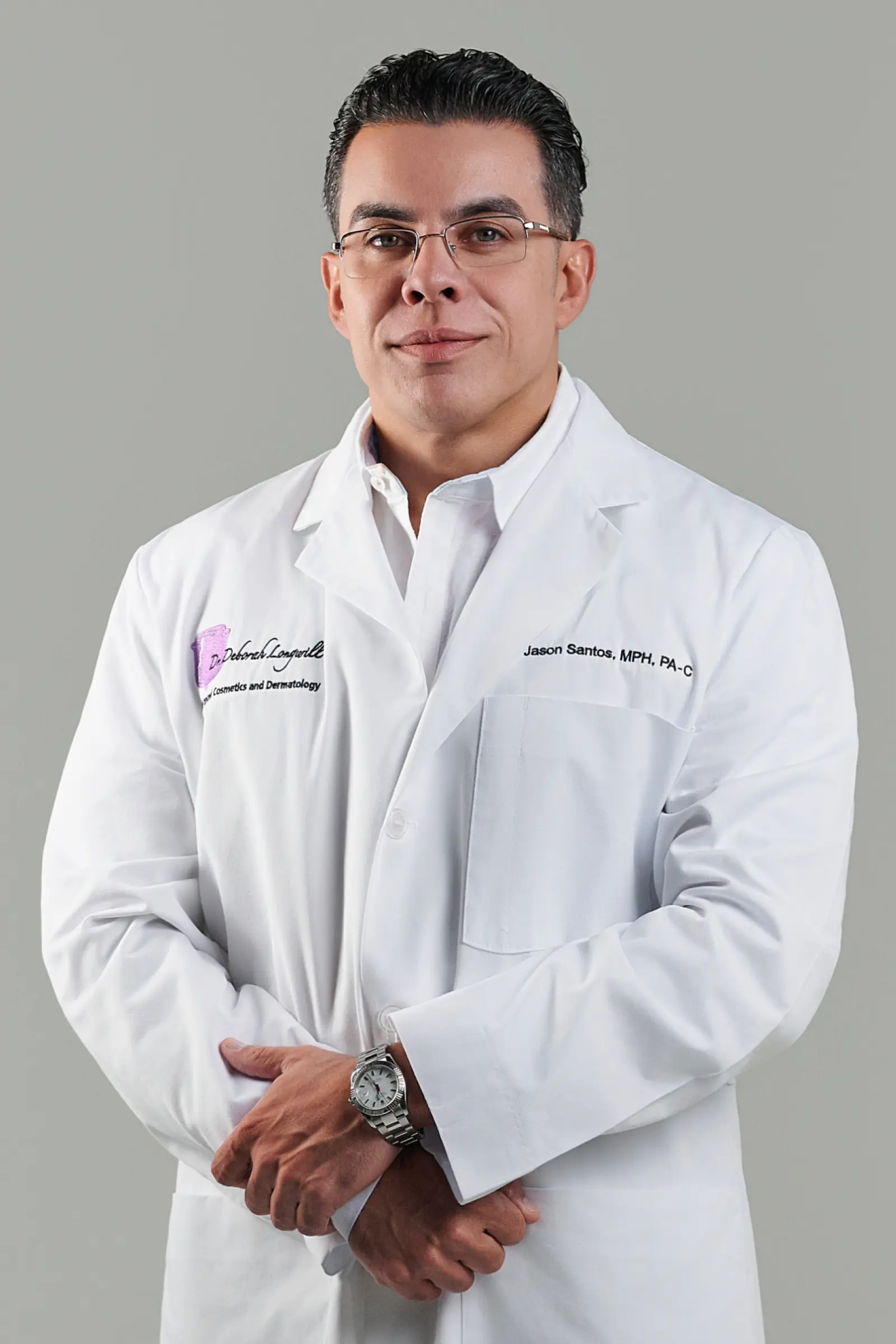 Male doctor in white coat standing confidently
